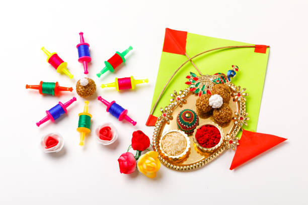 Indian festival makar sankranti concept, Kite String with Sesame seed ball or til ke laddo