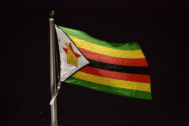 National flag soaring in sky, Flag waving proudly above clouds at sunrise