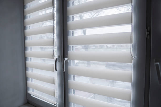 istock White fabric roller blinds on the white plastic window in the living room. Roll curtains indoor. 1197285606