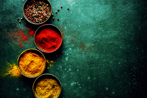 Tasty colorful spices on dark background with copy space. Food concept