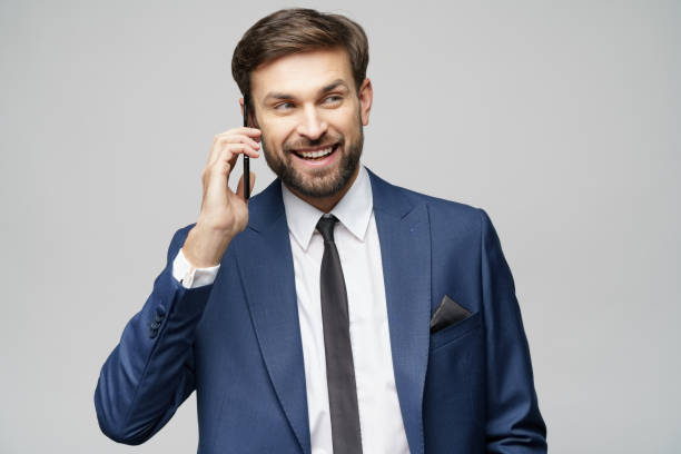 istock businessman talking on the phone isolated over grey background 1197289587