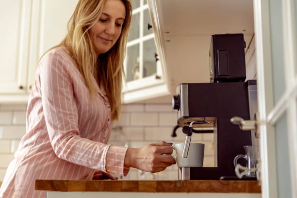 istock Young woman preparing morning coffee 1197289973