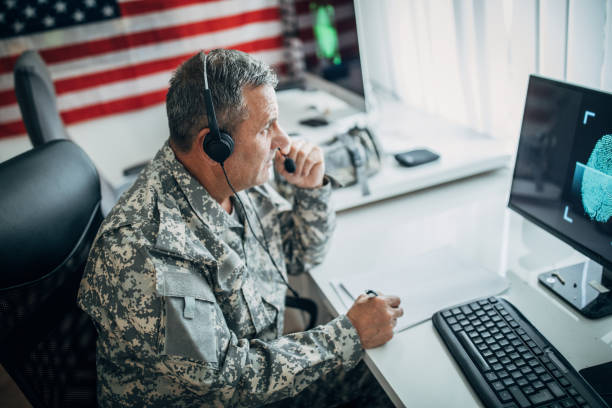 istock An old soldier sitting in an office uses a headset and a microphone 1197290903