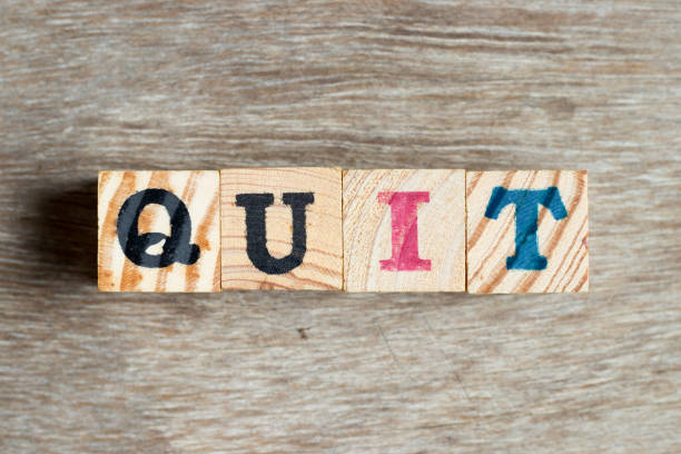 istock Letter block in word quit on wood background 1197292288