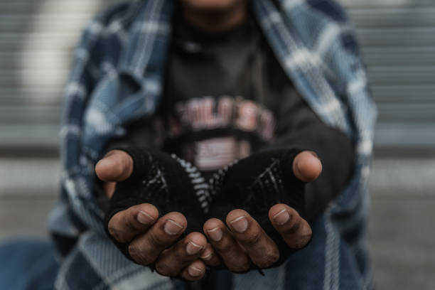 istock Man in need. Unhappy homeless man is holding hands to get help. 1197294631