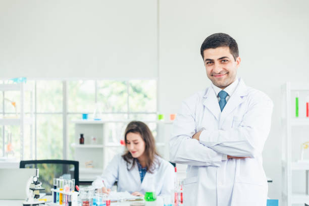 istock Smiling scientist leaning against the whiteboard in laboratory 1197294945