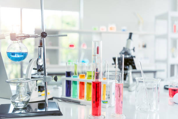 istock Chemical laboratory glassware with various colored liquids on table 1197294971