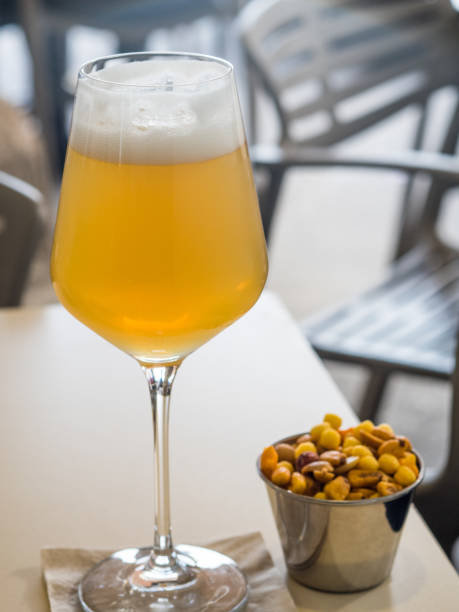 Cup of beer on table with snacks