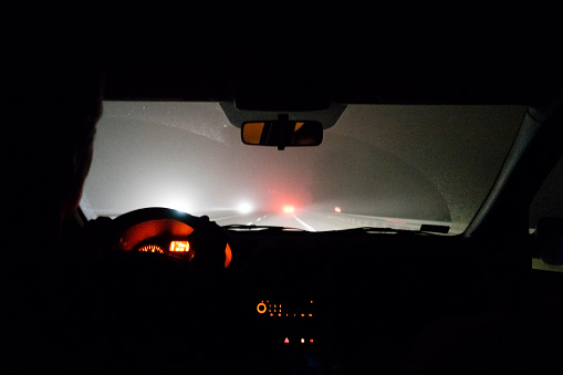Foggy road. View from driving car at night.