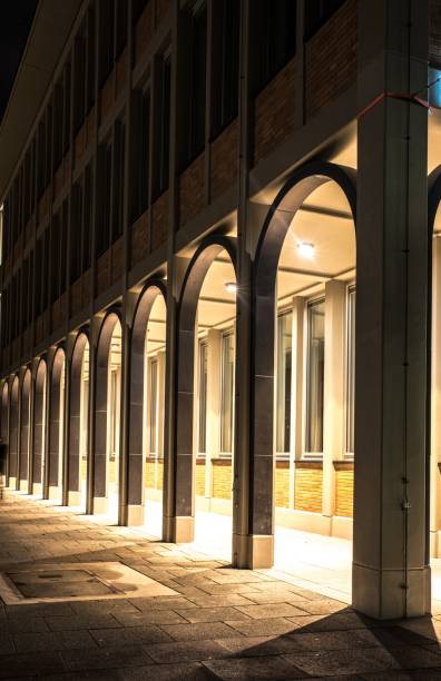 istock Curved arcade of a multi-storey house at night 1197296068