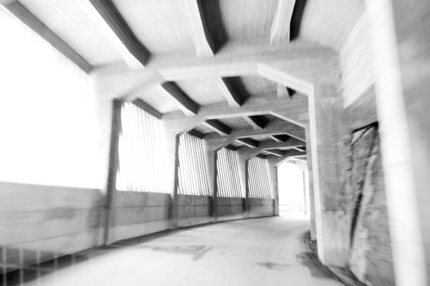 Blurry concrete tunnel with empty road. Curve on the road. Bend, turn.