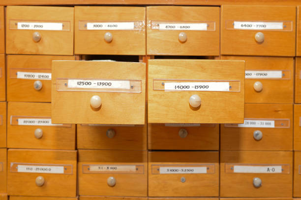 istock Database and data directory. A cabinet in a library with drawers for storing information cards. Book accounting system in a library or school. Finding information for training and work 1197298917
