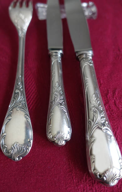 istock Silver metal cutlery placed on a red cotton tablecloth 1197299597