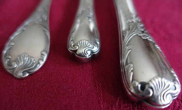 istock Silver metal cutlery placed on a red cotton tablecloth 1197299627