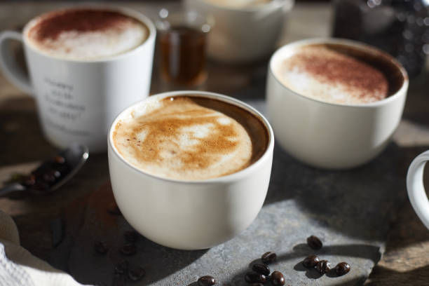 istock Hot coffee cup and coffee beans on wooden table. 1197301285