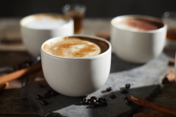 istock Hot coffee cup and coffee beans on wooden table. 1197301417
