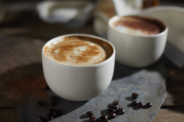 istock Hot coffee cup and coffee beans on wooden table. 1197302687