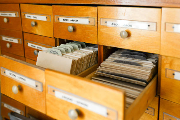 A file cabinet or cabinet with an open drawer and files. Database concept. File cabinet with library or office. Two drawers open. Ancient office