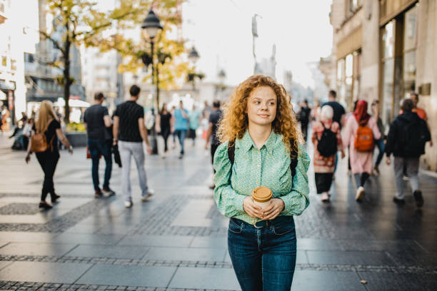 istock Lonely girl walking around town 1197305541