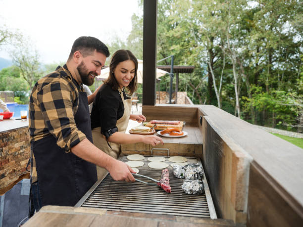 istock Happy hosts grilling in outdoor kitchen 1197306610