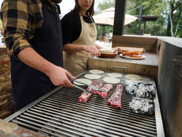 istock Host grilling carne asada in Mexico 1197306611