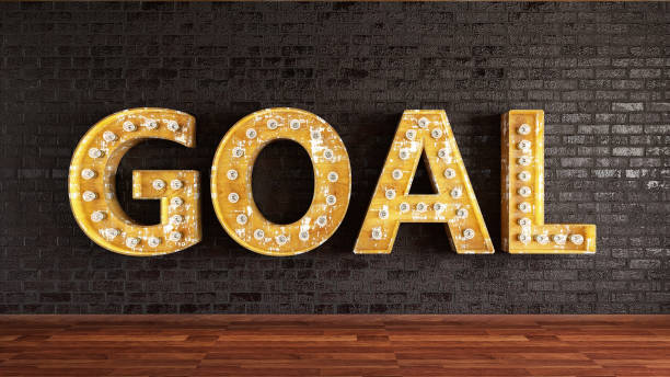 istock GOAL Sign with Light Bulbs on Black Brick Wall 1197309784