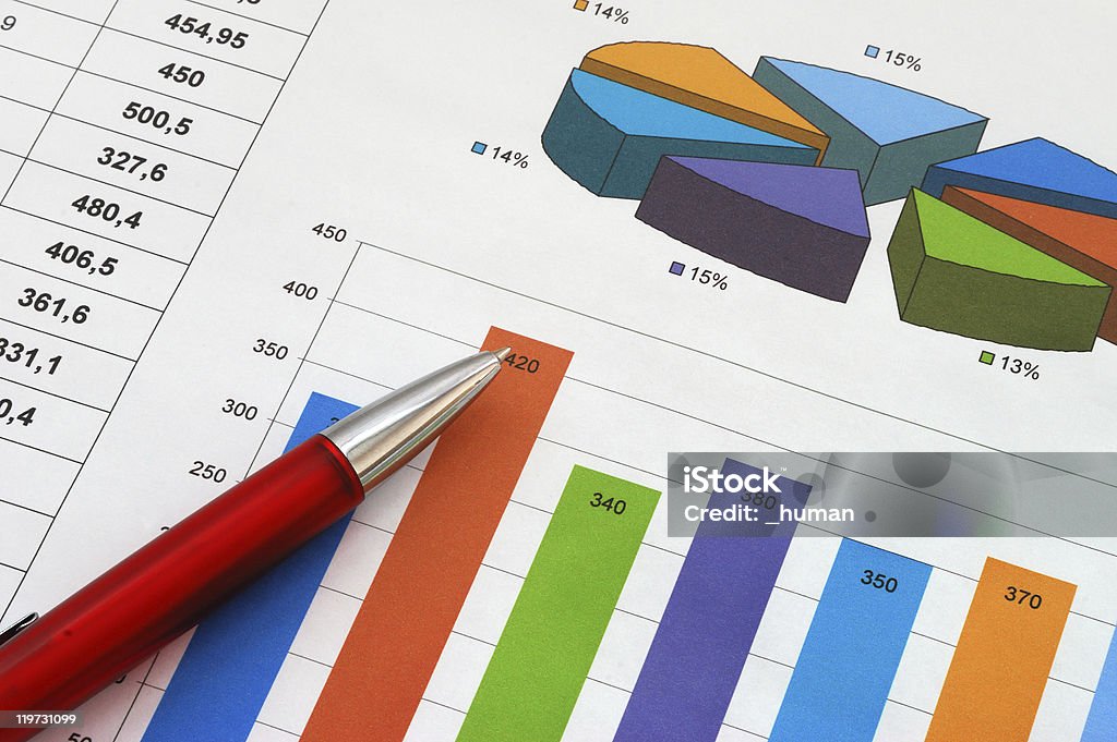 Finance report with colorful graphs and a red pen Close-up shot of a financial report with a row of numbers, a pie chart and a bar graph in multiple colors.  A red ballpoint pen, which is resting on top of the report, points upward. Analyzing Stock Photo