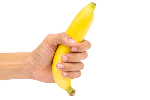 gli uomini delle mani tengono le banane su uno sfondo bianco - men banana holding cut out foto e immagini stock