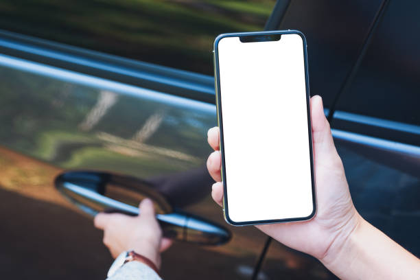 istock a woman holding and using mobile phone with blank screen while opening the car door 1197312210
