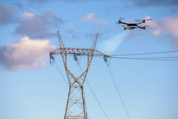 drone inspecting electricity power lines stock photo