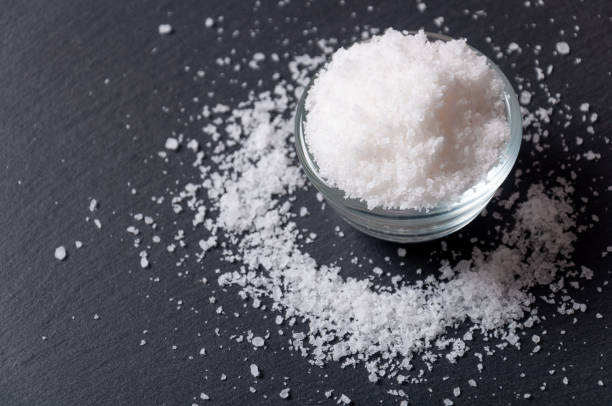 Sea Salt Salt on a black surface table. Salt stock pictures, royalty-free photos & images