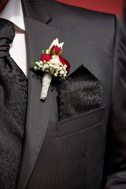 istock groom with buttonhole rose decoration 1197314683