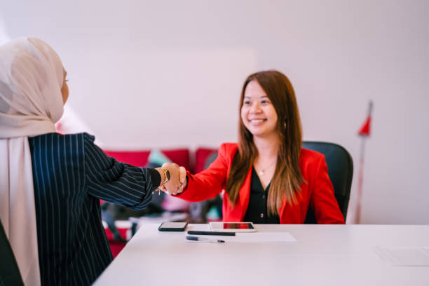 istock Two Beautiful Businesswomen Handshake 1197320496