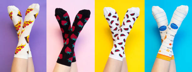 Female legs in colorful socks on colored background Female legs in colorful socks on colored background sock stock pictures, royalty-free photos & images