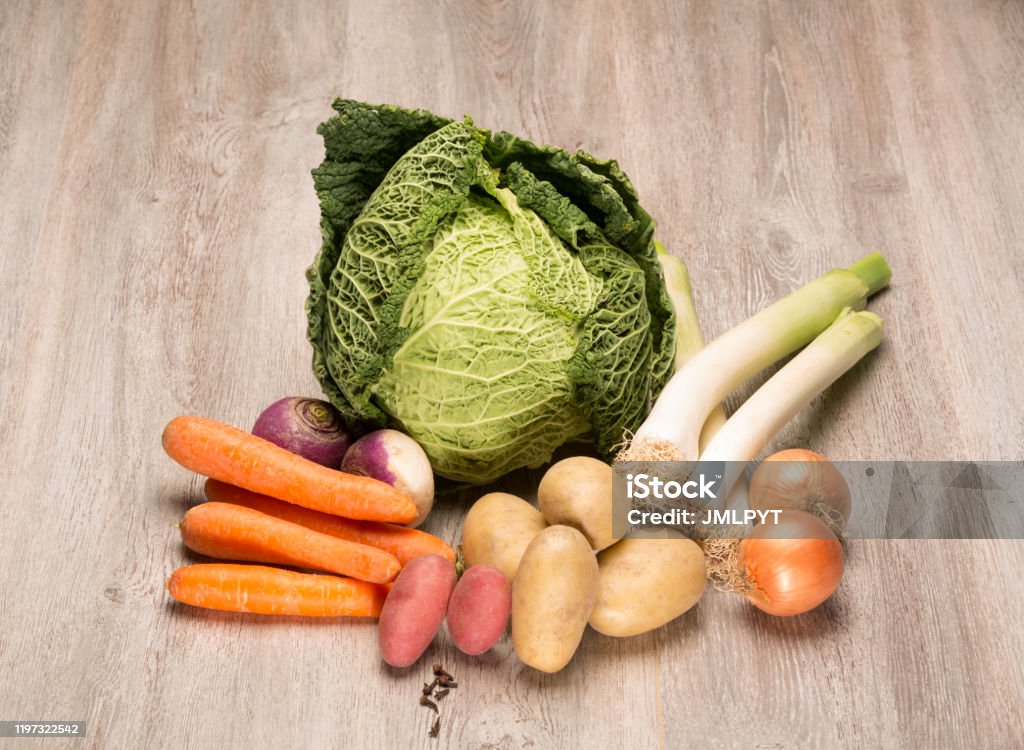 Seasonal vegetables for the preparation of the French "pot au feu" Seasonal vegetables for the preparation of the French "pot au feu"
assortment of vegetables to cook a pot au feu, French culinary specialty
there is a cabbage, carrots, turnip, potato, onion, leek, clove Pot-Au Feu Stock Photo