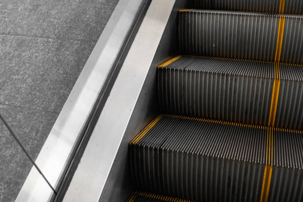 istock Ditry stairs on Escalator with yellow strips. 1197323919