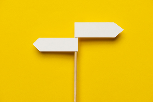 Two directional sign on the yellow background.