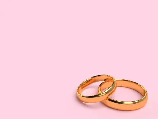 Two wedding gold rings lie on each other with blank space for text. 3d rendering