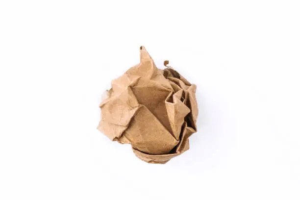 Photo of Crumpled paper ball. Isolated on white background. Concept for businnes, banner, web site and other. Vintage paper. Crumpled cardboard.