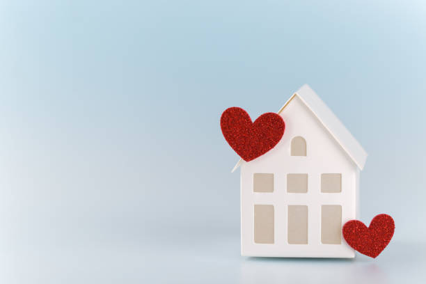 istock White little house with red hearts 1197332499