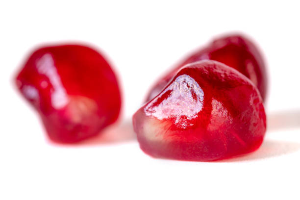 istock Fresh pomegranate seeds isolated on white background. Close up. 1197333008