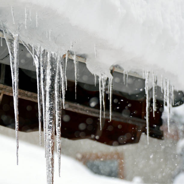 istock Icicles hanging from roof top 1197333587