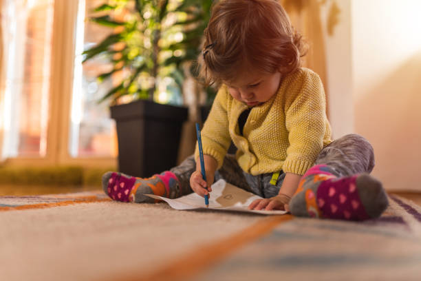 istock Young girl drawing on the floor 1197333738