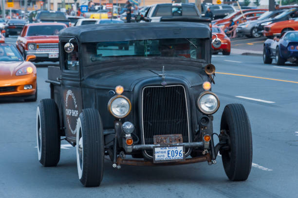 1934 Ford pickup truck styled rat rod Moncton, New Brunswick, Canada - July 11, 2015 : 1934 Ford pickup styled rat rod, Saturday evening cruising  on Mountain Road during 2015 Atlantic Nationals Automotive Extravaganza. cruising hot rods stock pictures, royalty-free photos & images
