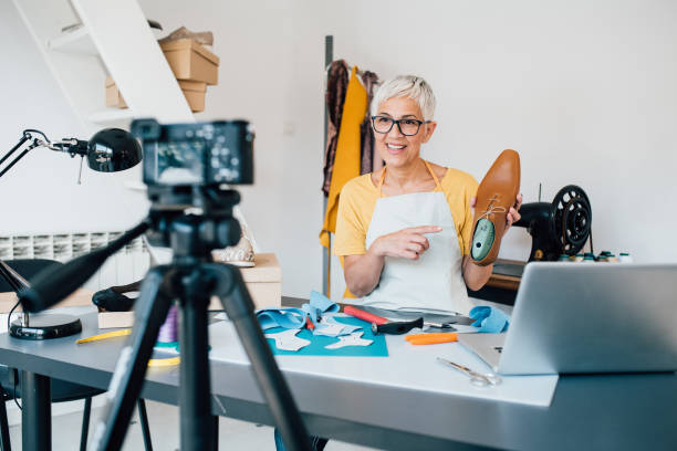 istock Shoemaker filming a video blog in her workshop 1197337544