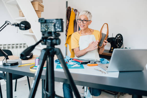 istock Mature shoemaker filming a video blog in her workshop 1197337548