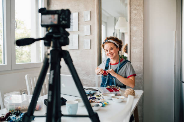 istock Young woman filming a tutorial for handmade jewelry 1197338426