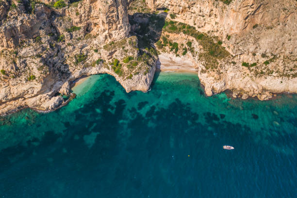 istock Aerial drone view on secret cozy beach sheltered between two rocky headlands Cala Moraig, Valencia community, Spain 1197338508