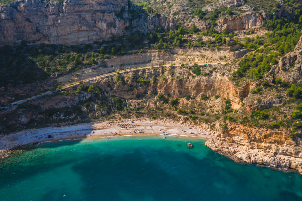 istock Aerial drone view on cozy beach Cala Moraig, Valencia community, Spain 1197338552