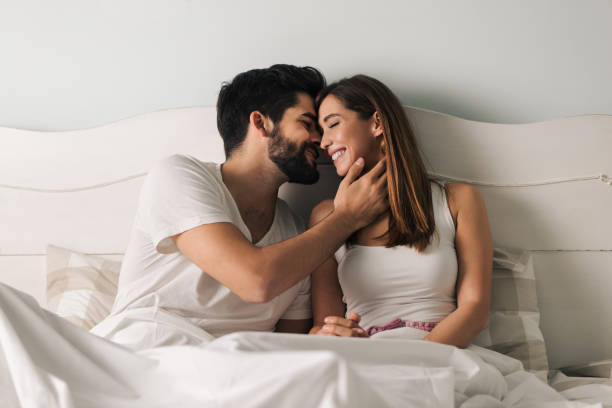 affectionate young couple in the bedroom - romance sensuality couple bed imagens e fotografias de stock